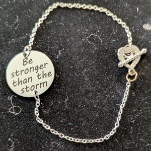 Delicate Silver Bracelet with Circular Pendant and Floral Clasp